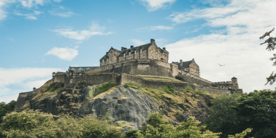 Iconic Edinburgh Castle, perched atop Castle Rock, symbolizes Scotland's rich history, culture, and architectural grandeur.