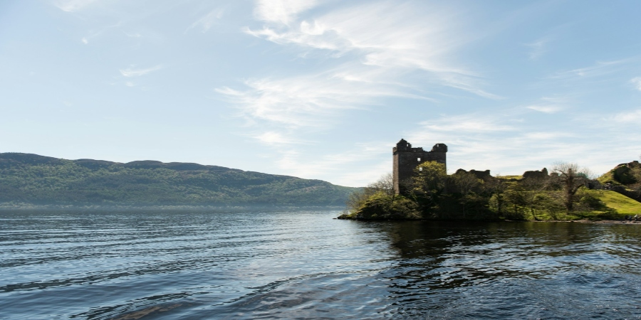 Tranquil Loch Ness near Edinburgh, Scotland, reflects serene waters amidst breathtaking Highland scenery.