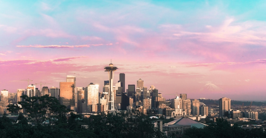 A stunning sky view of Seattle with vibrant pink hues in the backdrop, highlighting the city's iconic skyline and beauty.