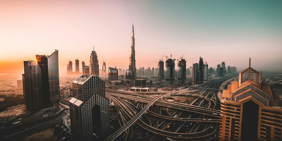 A breathtaking top view of Dubai's cityscape, showcasing its impressive skyscrapers and vibrant urban landscape under a clear sky.