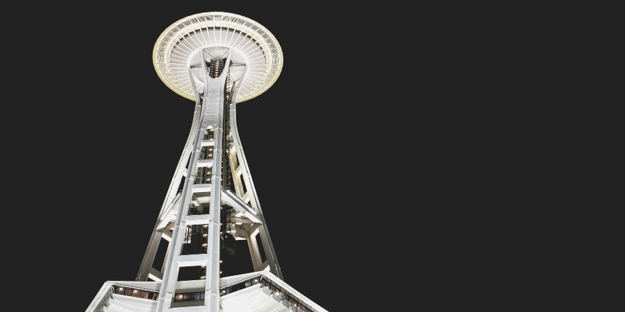 A breathtaking night view of Seattle’s iconic Space Needle, beautifully lit up, as seen from the Seattle hop-on hop-off tour.