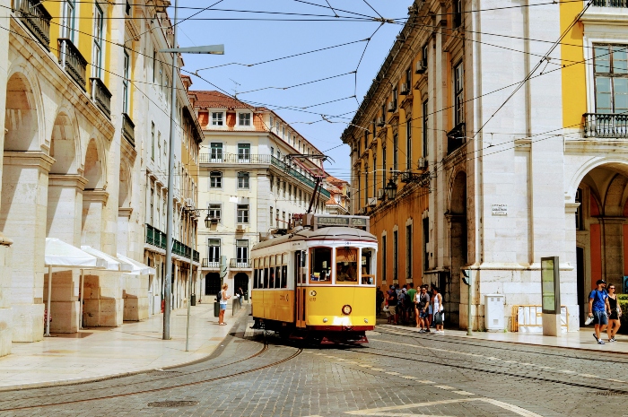 A yellow tram rattling through the streets of the city.