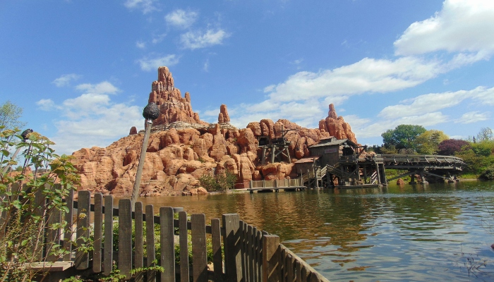 A part of Disneyland Paris with a water in the foreground.