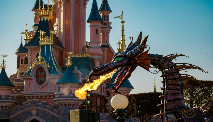 A dragon with fire in mouth in front of Disneyland Paris.