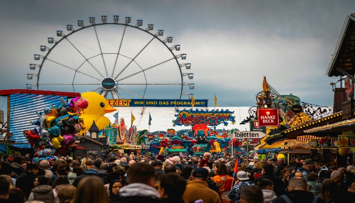 Picture showcasing giant ferries wheel and crowds