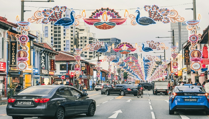 Colorful decorations and bustling traffic in Little India Singapore, a cultural neighborhood visited through Singapore city tours and bus routes.