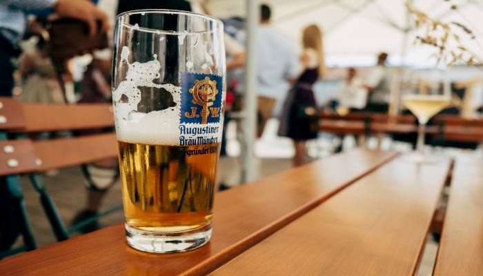 Close-up of Augustiner beer on a wooden table in a beer garden, a classic Munich landmarks and beer gardens experience.
