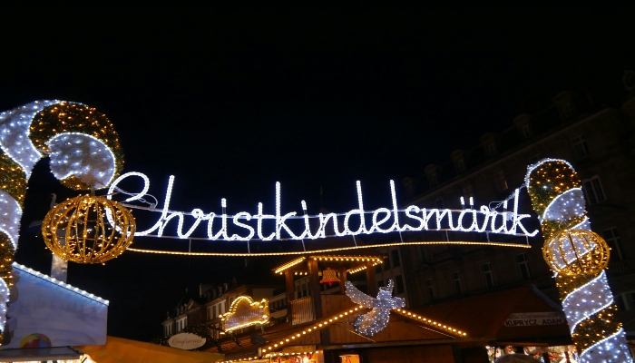 Christkindelsmärik market entrance sign sparkling at night, welcoming visitors to one of the best Christmas markets in Europe.