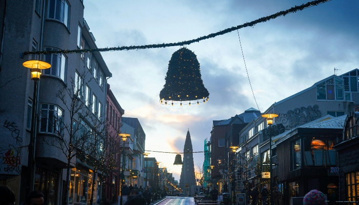 Reykjavik’s main street draped in Christmas lights, with Hallgrimskirkja church in the background, celebrating Iceland's unique place among european festive cities.