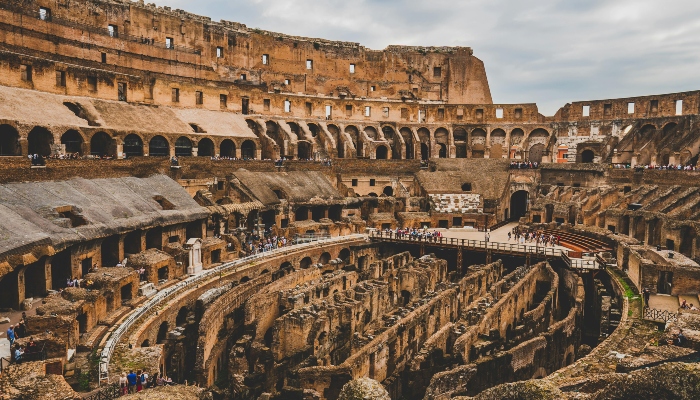 Interior view of the Colosseum in Rome, showing ancient seating tiers and pathways, a key landmark mentioned in do’s and don’ts in Rome travel advice.