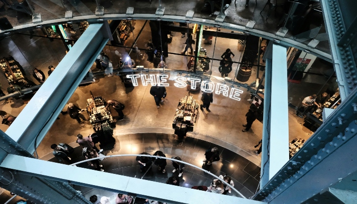 Interior view of the Guinness Storehouse gift shop with visitors browsing merchandise.