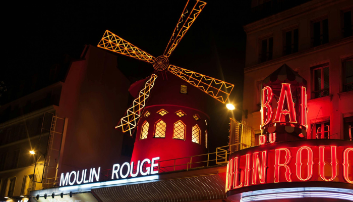 Moulin Rouge illuminated at night in Montmartre, showcasing iconic Paris nightlife during Valentine’s Day in Paris.