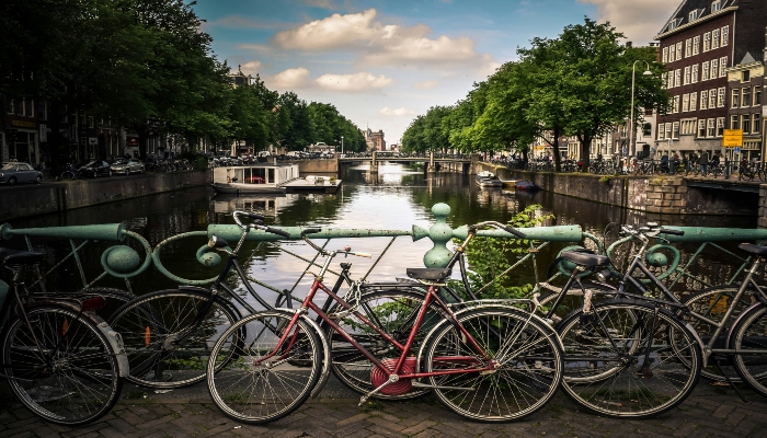 Amsterdam canal view with bicycles on a bridge near the Van Gogh Museum area.