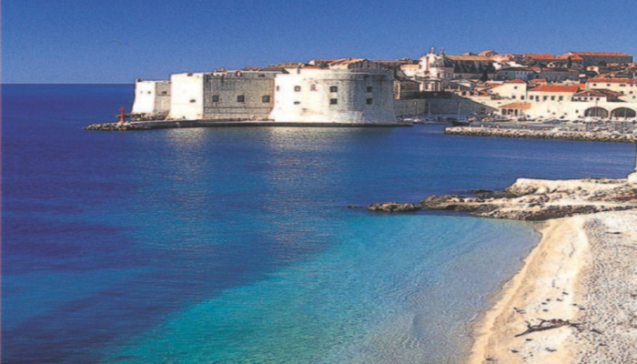 Dubrovnik Old Town fortress and Adriatic coastline with clear blue water.