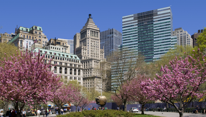 Lower Manhattan city skyline and park near Financial District along NYC sightseeing bus route.