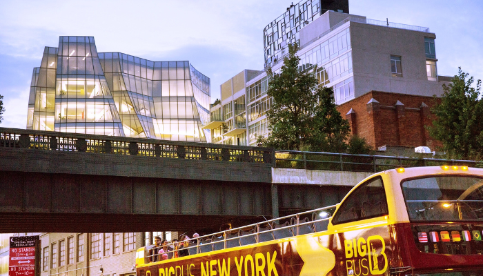 Big Bus New York hop-on hop-off sightseeing bus passing the High Line in Manhattan.