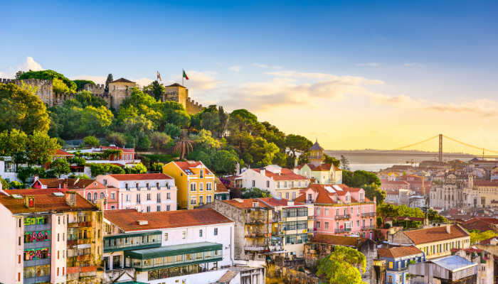 Colorful houses and hilltop views of Lisbon with the Tagus River during spring.