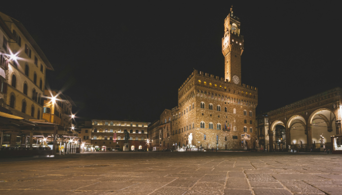 Palazzo Vecchio illuminated at night in Piazza della Signoria, historic landmark included in a one day in Florence route.