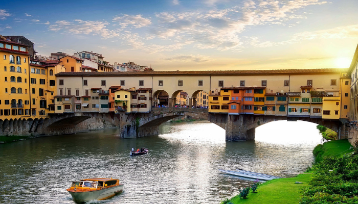Ponte Vecchio bridge over the Arno River at sunset, iconic crossing on the best way to see Florence in one day.