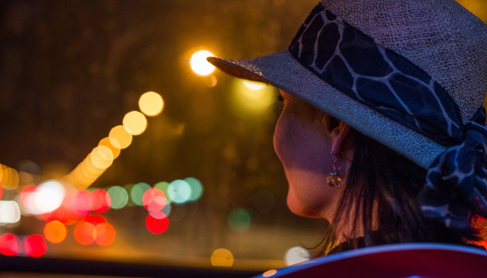 Traveler enjoying evening city lights from a Florence sightseeing bus during their visit to Florence for one day.