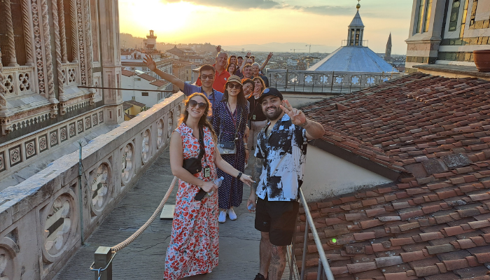 Visitors walking along Florence Cathedral rooftop terrace with panoramic city views on their walking tour in Florence.