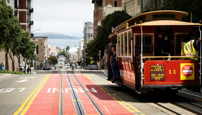 Historic Powell Street cable car traveling downhill toward the waterfront in San Francisco.