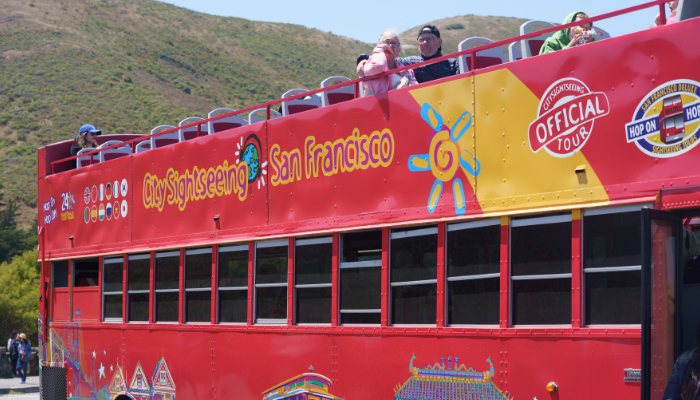 Open-top hop-on hop-off sightseeing bus tour in San Francisco ideal for first time visitors exploring major attractions.