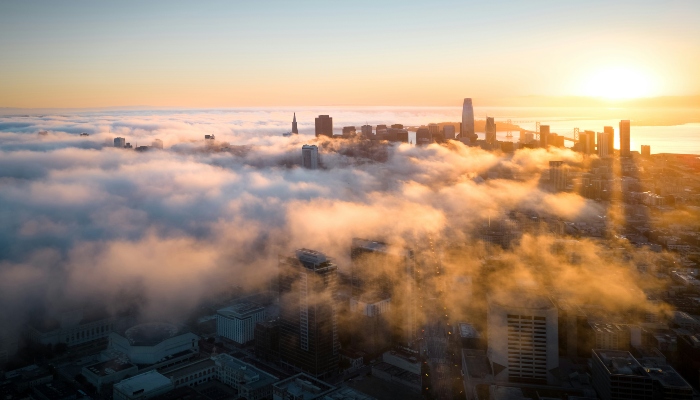 Downtown San Francisco skyline rising through morning fog, a classic view of San Francisco for first time visitors.
