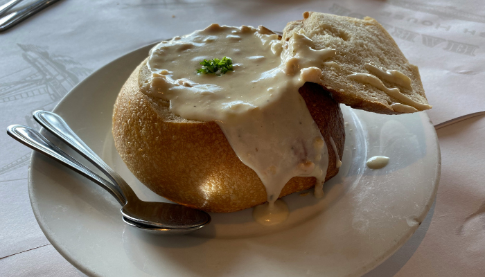 Clam chowder served in a sourdough bread bowl, a classic San Francisco food experience for first time visitors.
