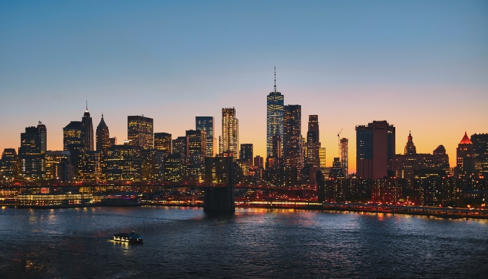 Manhattan skyline glowing at dusk along the East River, a must-visit summer destination in the US.