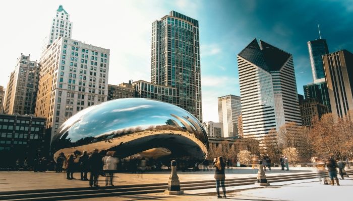 The Bean sculpture reflecting Chicago skyline at Millennium Park, a top summer city break in the US.