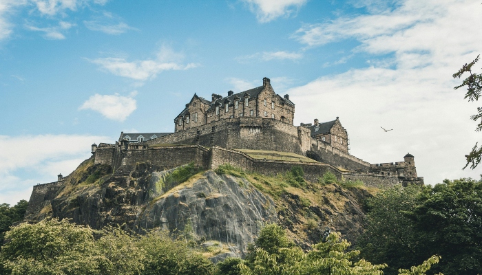 Edinburgh Castle sitting dramatically on Castle Rock overlooking the city skyline.