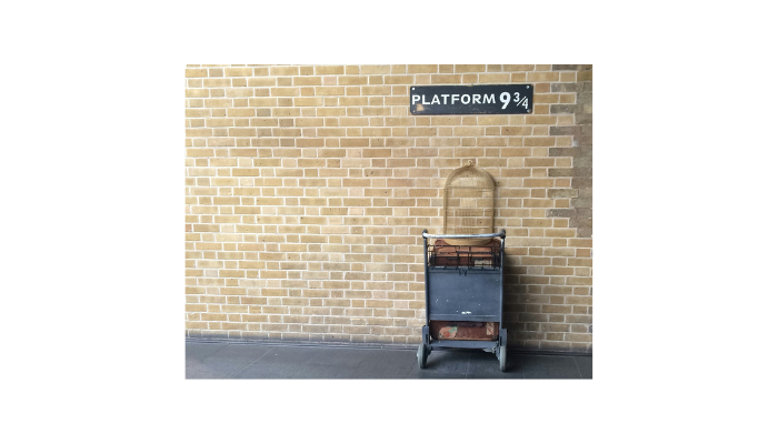 Platform 9¾ sign and luggage trolley display at King’s Cross Station in London inspired by Harry Potter.