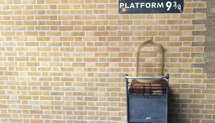 Platform 9¾ sign and luggage trolley display at King’s Cross Station in London inspired by Harry Potter.