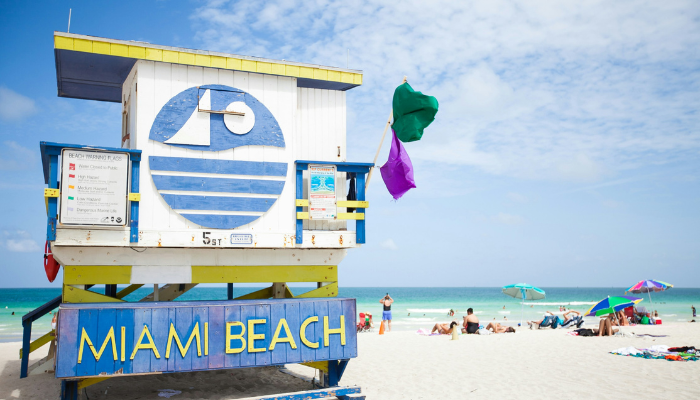 Miami Beach lifeguard tower near South Beach with ocean views and colorful umbrellas in a famous LGBTQ travel hotspot.