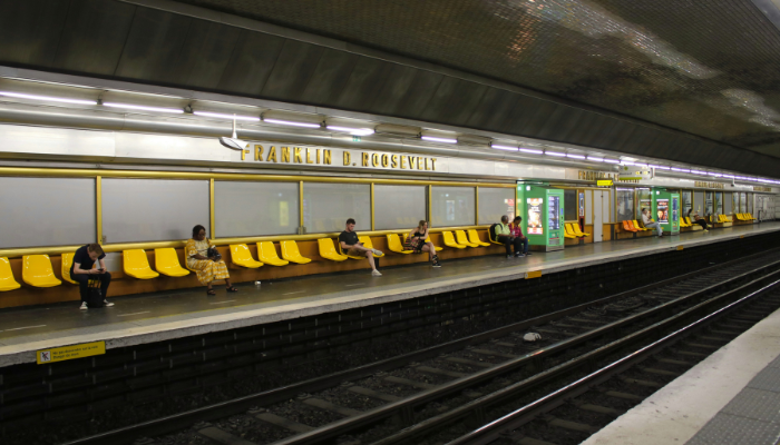 Passengers waiting at a Paris metro station platform, highlighting public transport used for quick travel across the city.