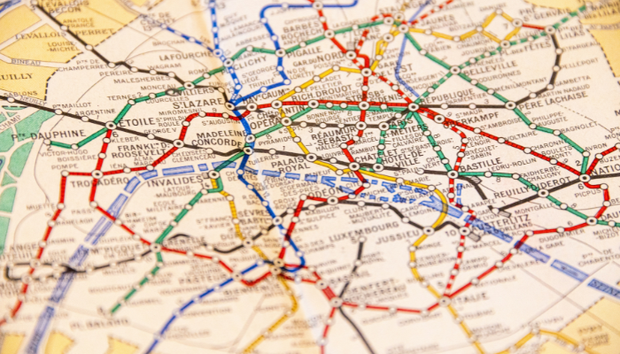 Close-up of a Paris metro map showing colorful train routes used by tourists and locals to travel across the city.