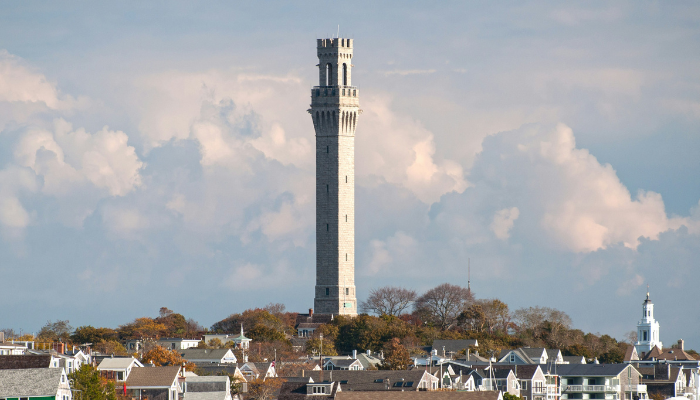 Provincetown Monument rising above Cape Cod rooftops in one of America’s most beloved LGBTQ beach communities.