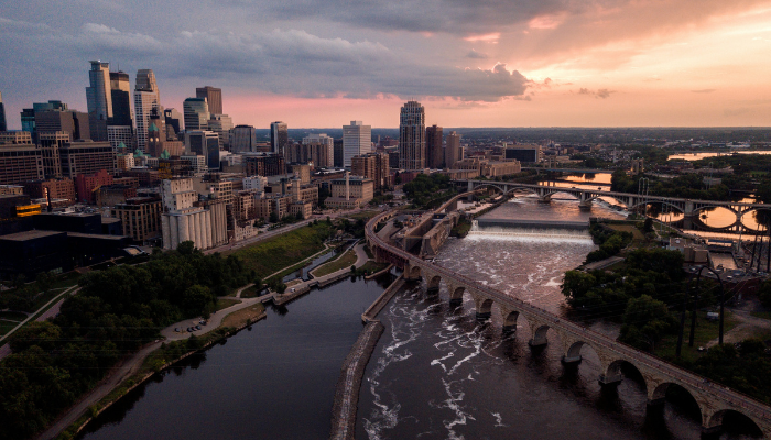 Aerial skyline view of Minneapolis at sunset with rivers and bridges in one of America’s growing LGBTQ-friendly cities.