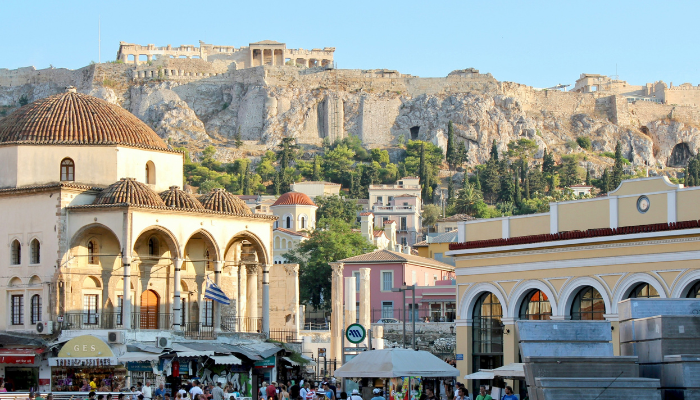 Monastiraki Square in Athens with traditional buildings and the Acropolis rising above the city.