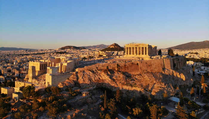 Sunset view of the Acropolis hill and the Parthenon overlooking the historic centre of Athens.