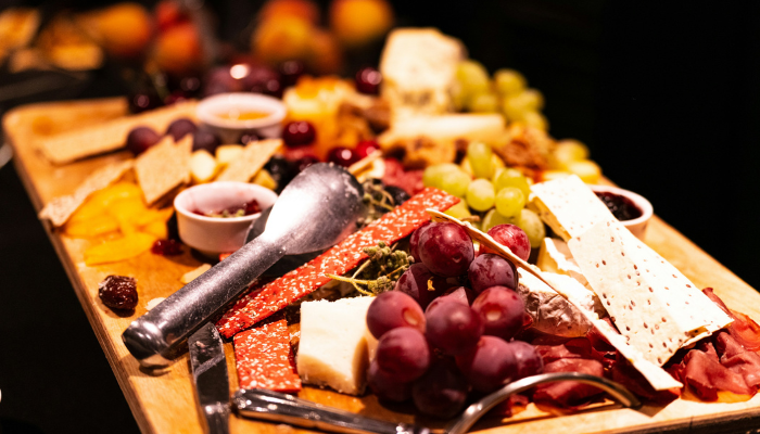 Traditional Greek meze platter featuring cheeses, cured meats, grapes, and appetisers served in Athens.