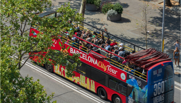 Barcelona City Tour hop-on hop-off bus traveling through the city, providing sightseeing access to Barcelona's top attractions.