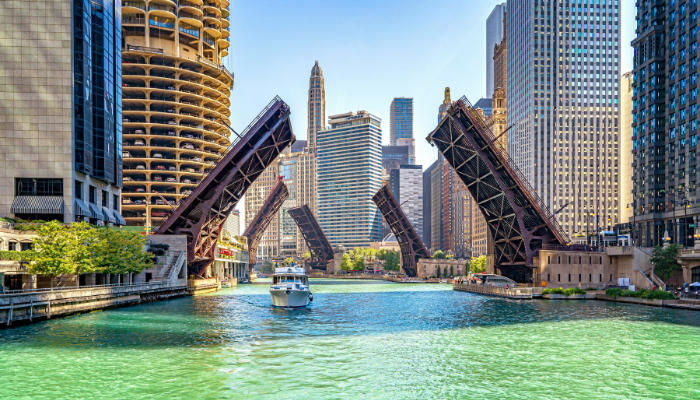 Tour boat navigating the Chicago River as raised drawbridges frame the city's famous skyline during an architecture sightseeing cruise.