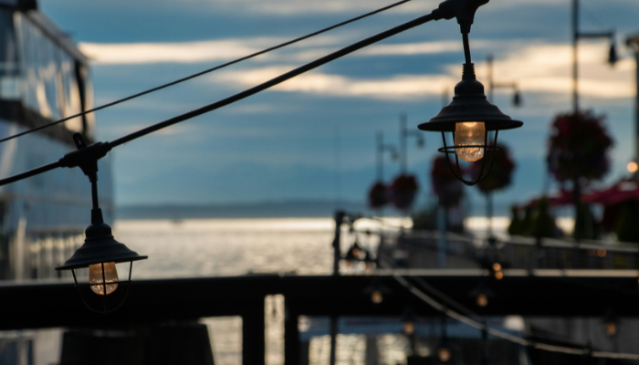 Atmospheric waterfront setting at sunset with decorative lights overlooking Lake Michigan, capturing the ambiance of Chicago evening and dinner cruises.