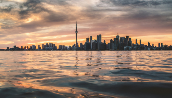 Toronto skyline at sunset reflected over Lake Ontario during FIFA World Cup 2026 travel in Canada