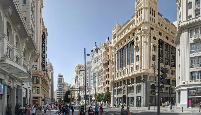 Elegant architecture and bustling atmosphere along Gran Vía in Madrid.