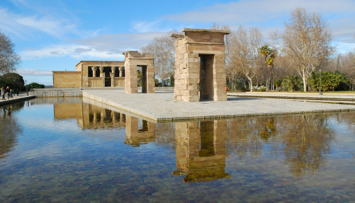 Ancient Temple of Debod reflected in water at one of Madrid's most scenic landmarks.