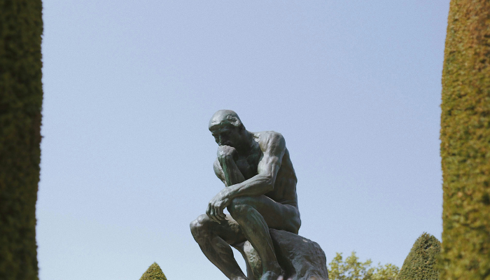 Auguste Rodin's famous sculpture The Thinker displayed in the peaceful sculpture garden at Musée Rodin in Paris.