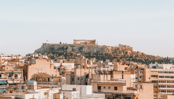 Athens city skyline with the Acropolis rising above the historic center, showcasing the route covered by sightseeing buses.